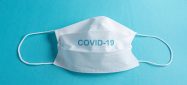 Surgical mask over minimalist blue background Surgical mask over minimalist blue background