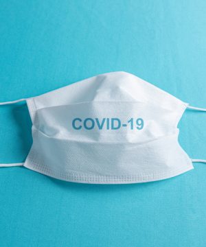 Surgical mask over minimalist blue background Surgical mask over minimalist blue background